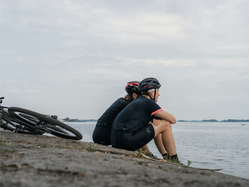 Cyclists resting by the lakeside.