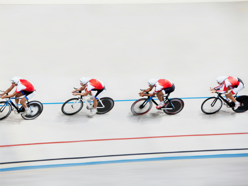 Four cyclists racing on a track