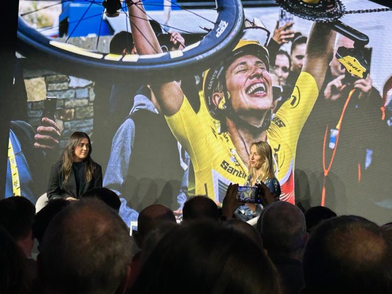 Two women speaking at a cycling event.